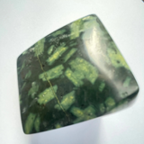 Green and black patterned stone on a white background